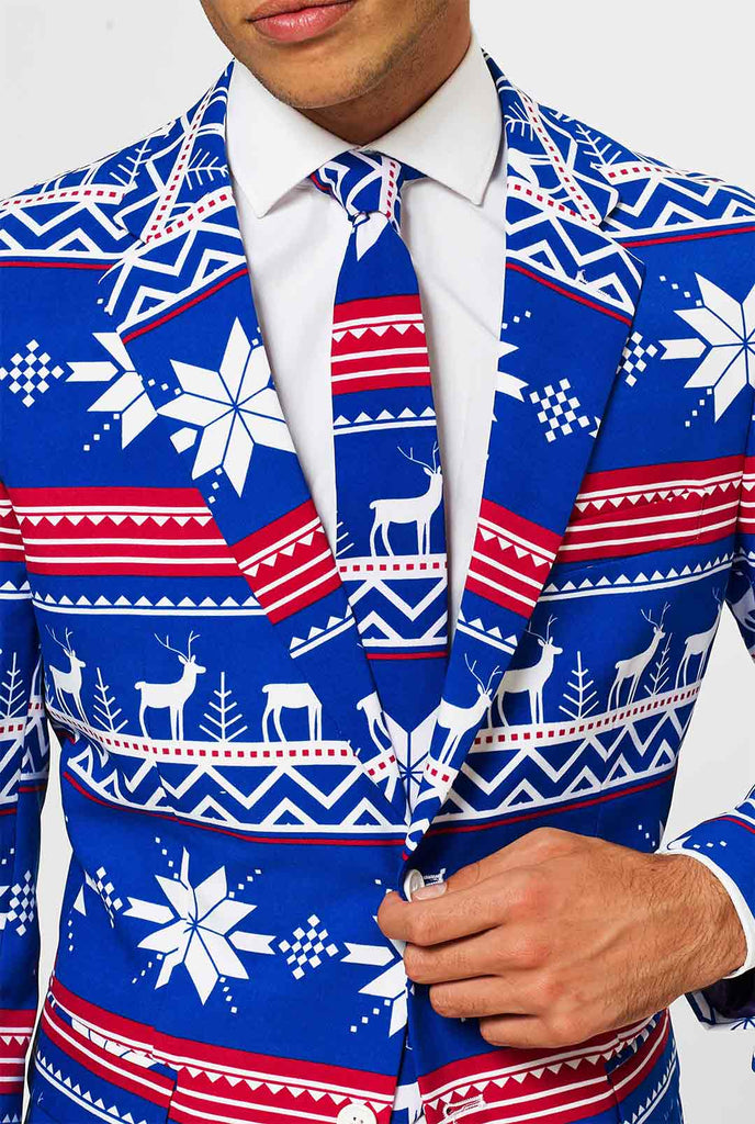 Man wearing blue Christmas suit with Nordic themed print