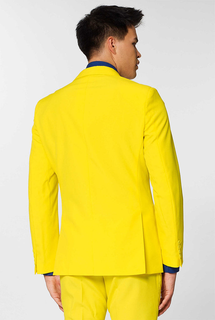 Man wearing yellow men's suit and dark blue dress shirt