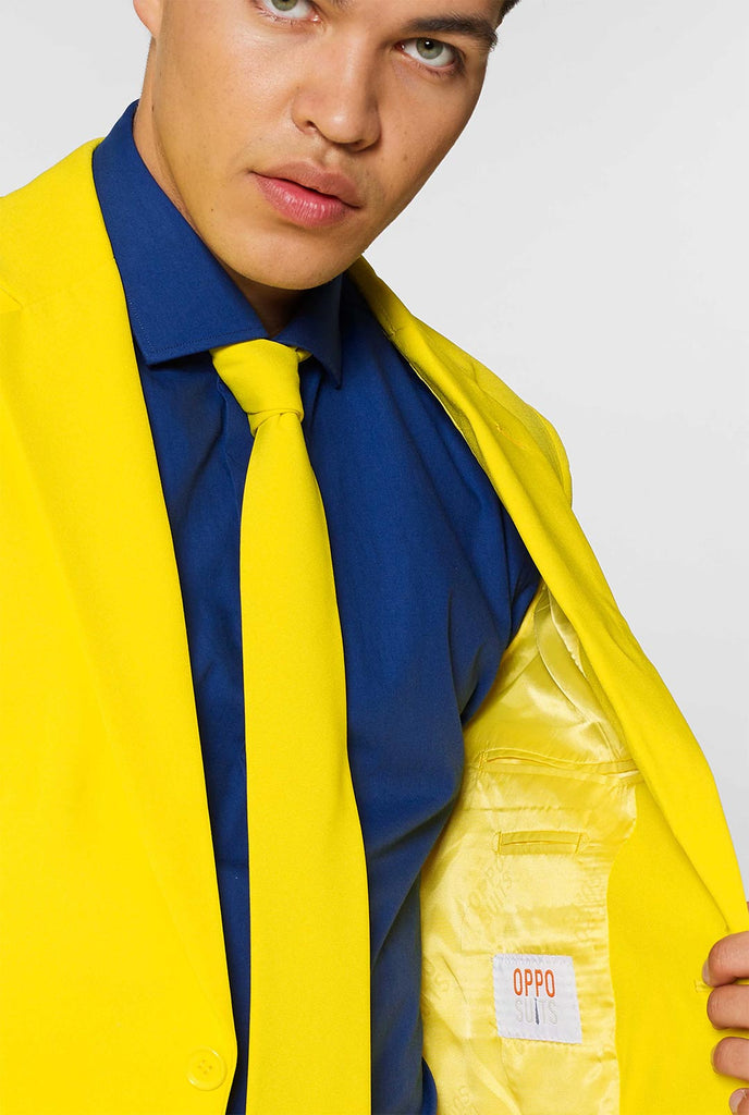 Man wearing yellow men's suit and dark blue dress shirt