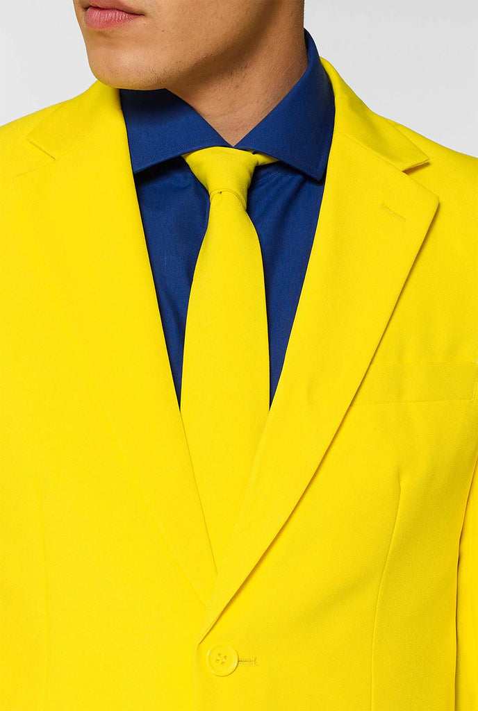 Man wearing yellow men's suit and dark blue dress shirt