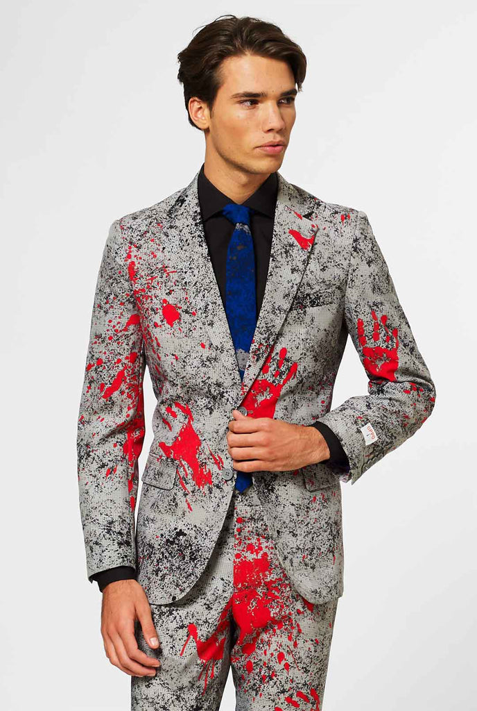 Man wearing grey Halloween men's suit with blood stains