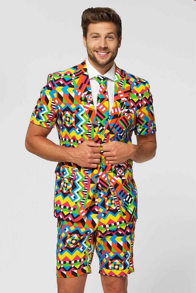 Man wearing colorful summer suit, consisting of short, jacket and tie
