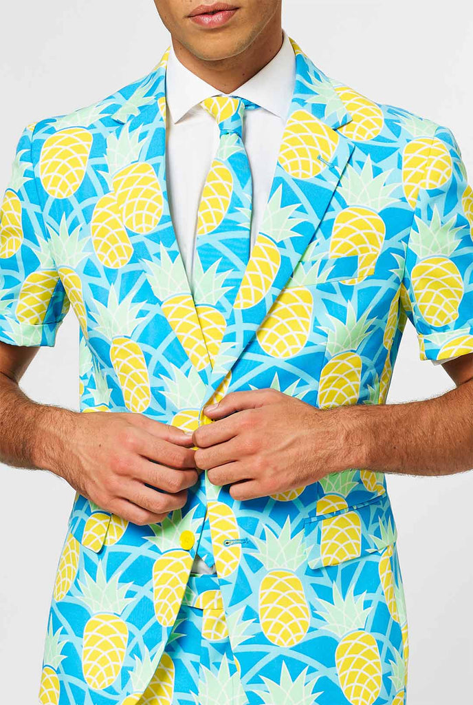 Man wearing blue summer suit with pineapple print