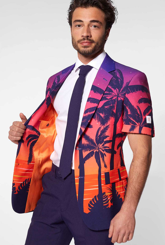 Man wearing summer suit with palms and sunset print