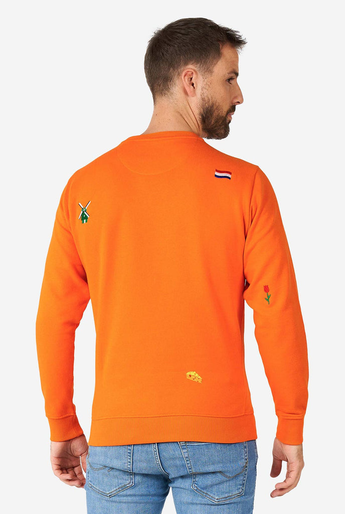 Man wearing orange sweater with Dutch icons