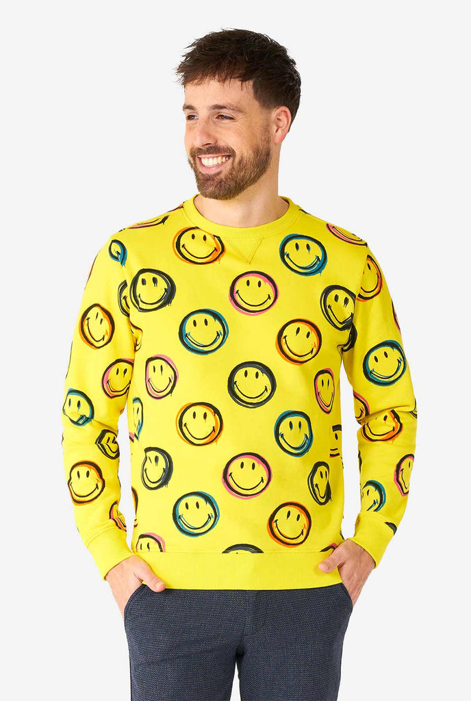 Man wearing yellow men's sweater with Smiley print