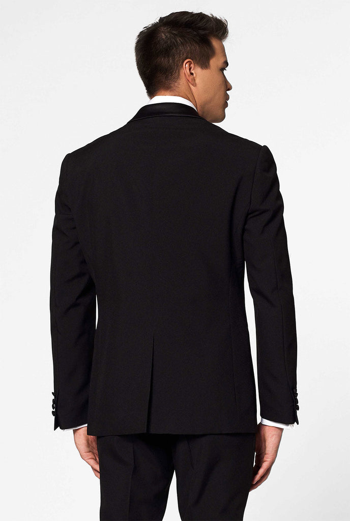 Solid black tuxedo suit Jet Set Black worn by man close up
