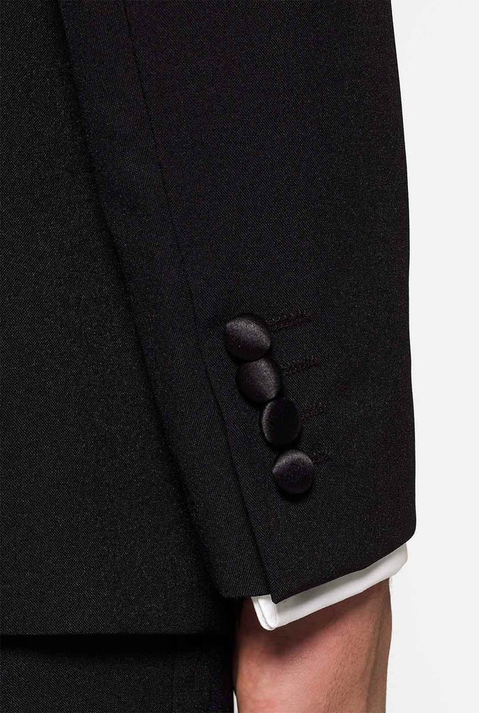 Solid black tuxedo suit Jet Set Black worn by man close up