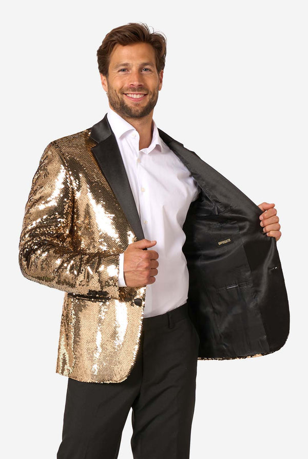 Man wearing a gold sequin blazer over a white shirt on a white background