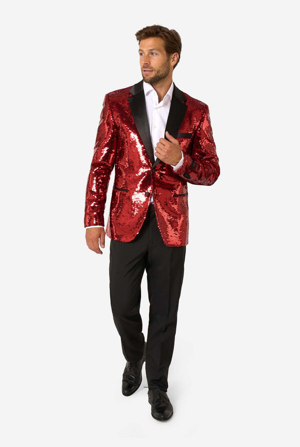 Man wearing a red sequin blazer with black lapels on a white background
