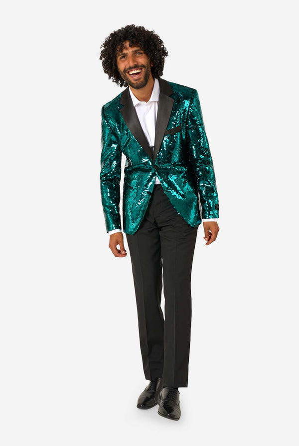 Man wearing a green sequin blazer and black pants on a white background