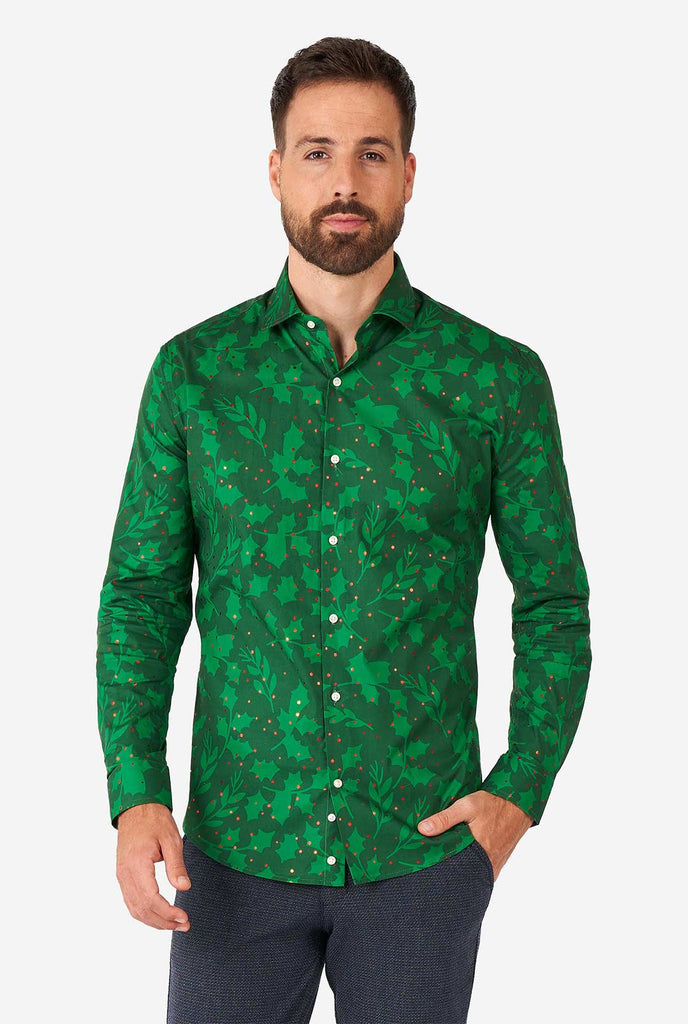 Man wearing green Christmas dress shirt with holly and mistletoe print