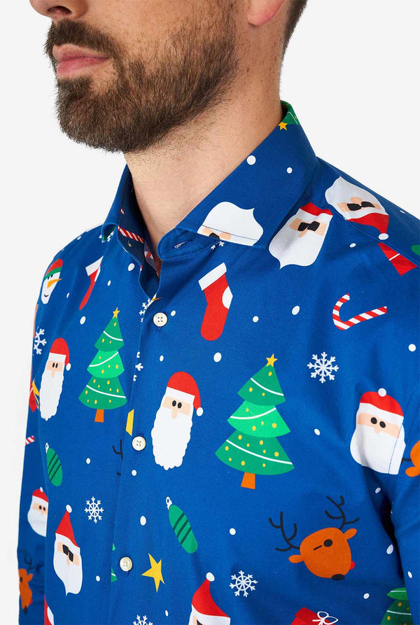 Man wearing blue Christmas dress shirt with Christmas icons