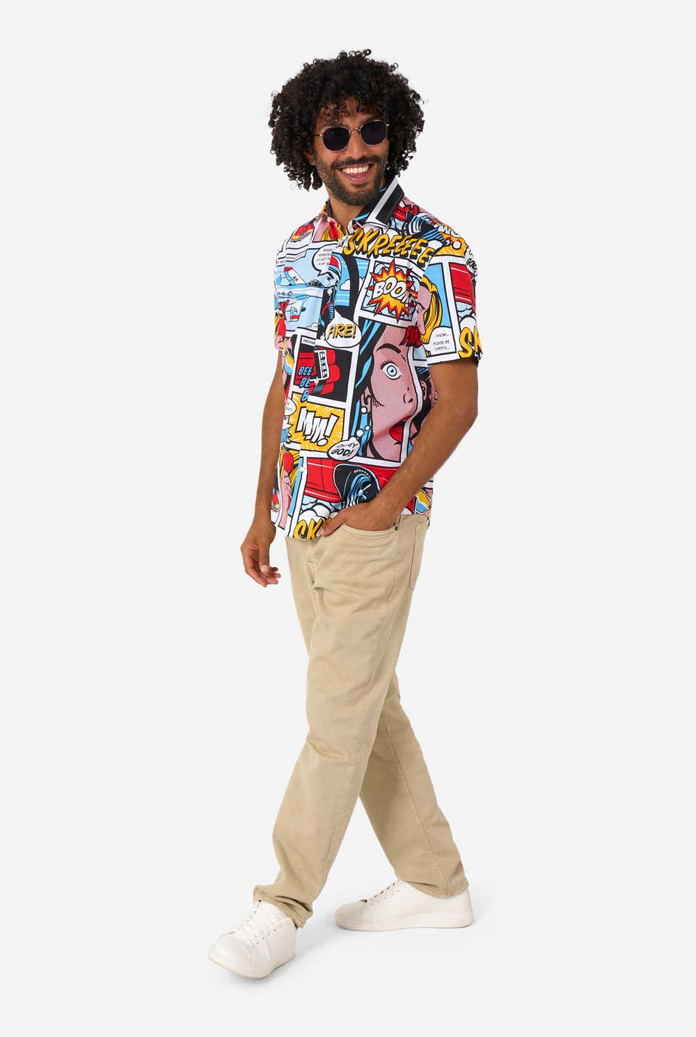 Man wearing a colorful comic-style shirt with sunglasses on a white background