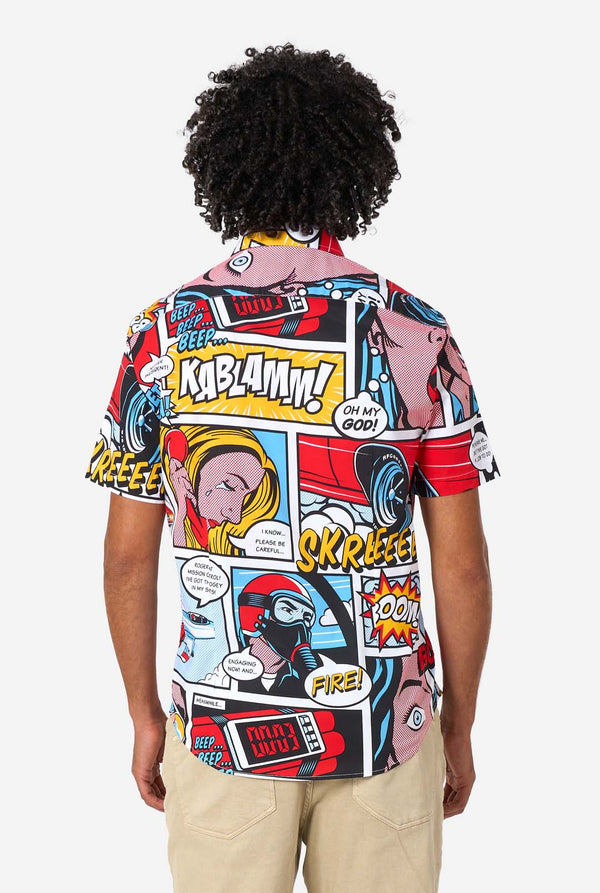 Man wearing a colorful comic-style shirt with sunglasses on a white background. View from the back