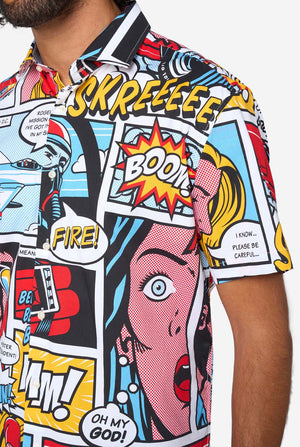 Man wearing a colorful comic-style shirt with sunglasses on a white background. Close up of the chest