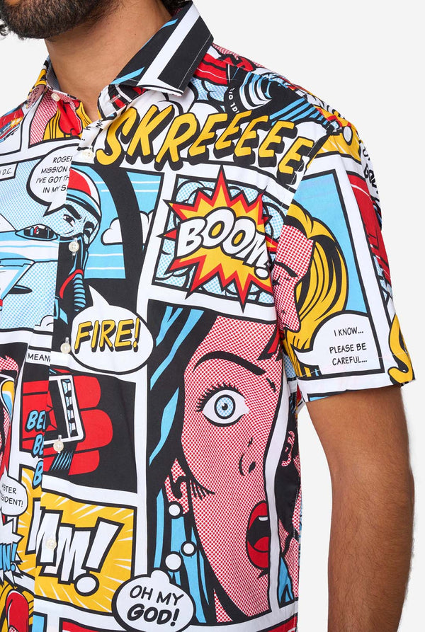 Man wearing a colorful comic-style shirt with sunglasses on a white background. Close up of the chest