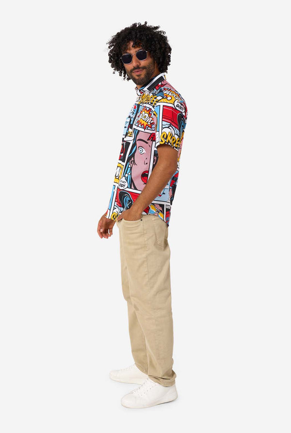 Man wearing a colorful comic-style shirt with sunglasses on a white background. Side view, full body image