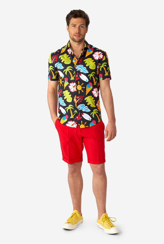Man wearing black summer shirt with tropical icons and red short
