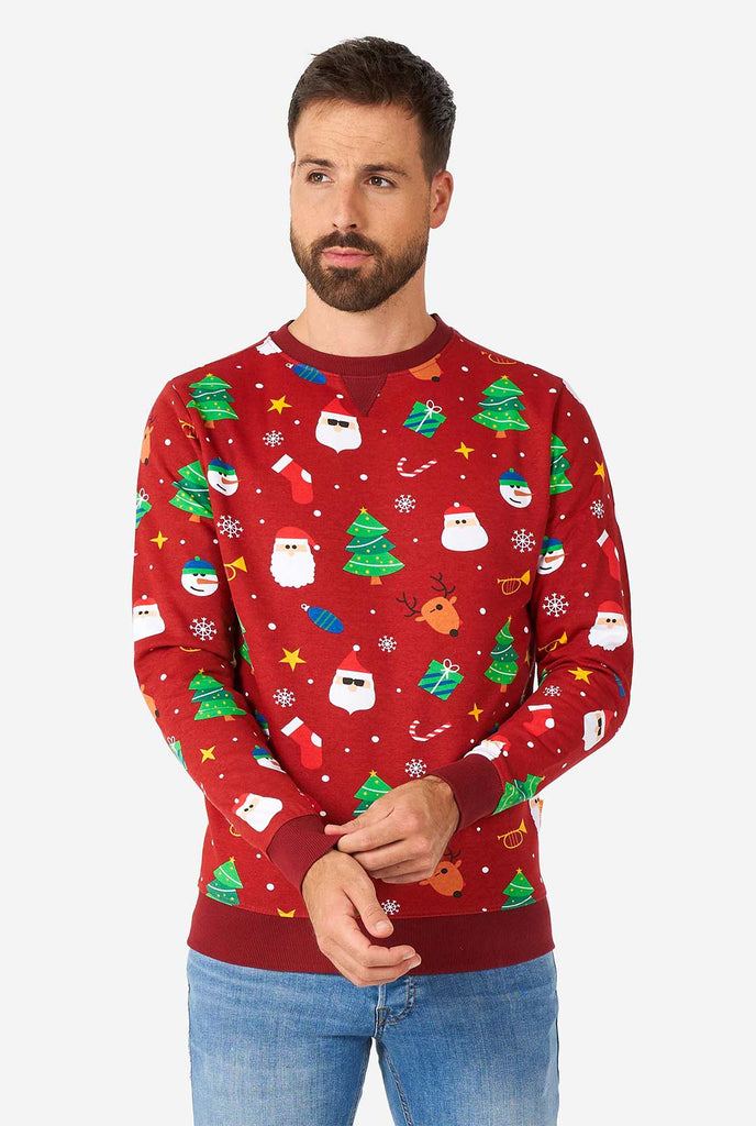 Man wearing red Christmas sweater with Christmas icons