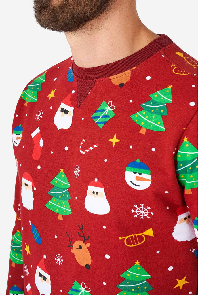 Man wearing red Christmas sweater with Christmas icons