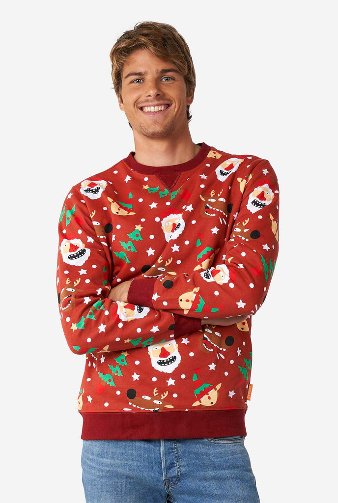 Man wearing red Christmas sweater with Christmas icons