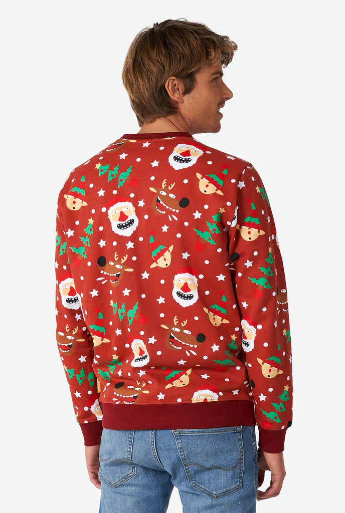 Man wearing red Christmas sweater with Christmas icons