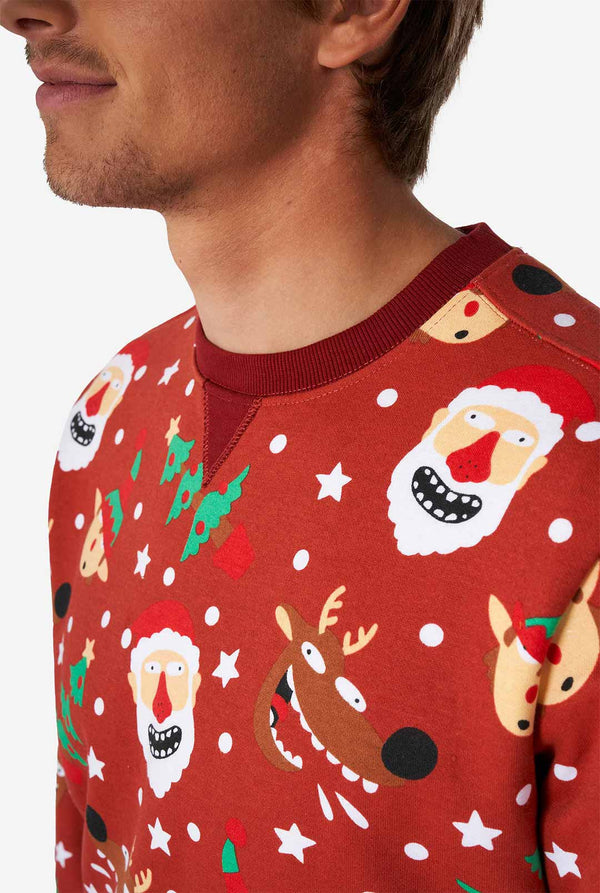 Man wearing red Christmas sweater with Christmas icons