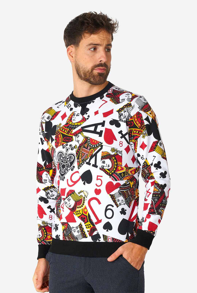 Man wearing white sweater with playing cards print