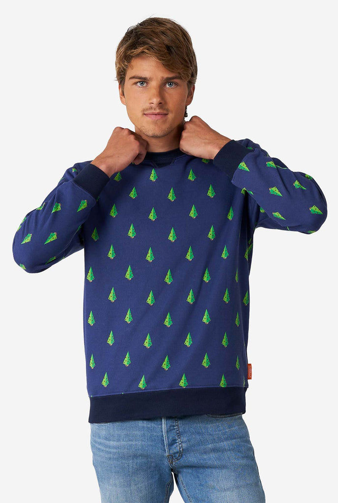 Man wearing blue Christmas sweater with Christmas tree print