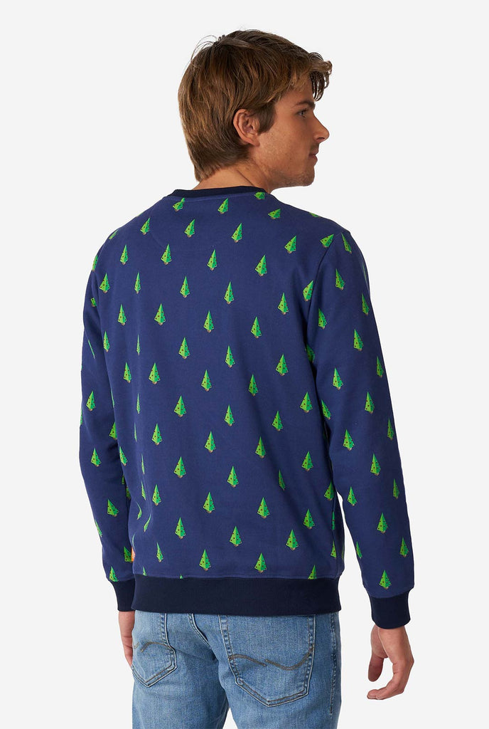 Man wearing blue Christmas sweater with Christmas tree print