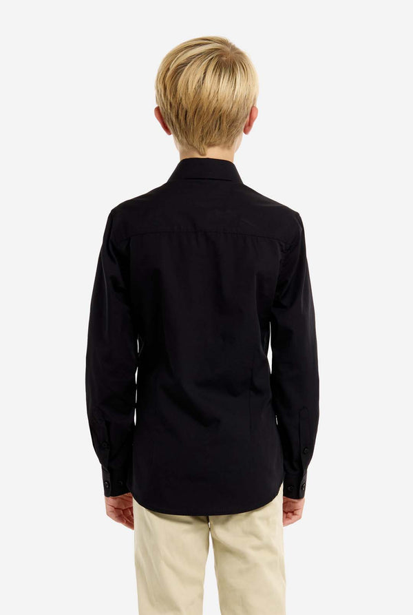 Person wearing a black shirt and beige pants on a white background