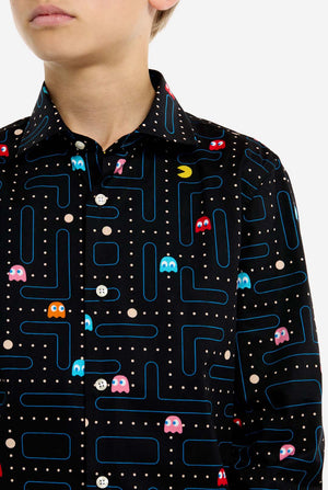 Person wearing a black shirt with colorful Pac-Man game pattern
