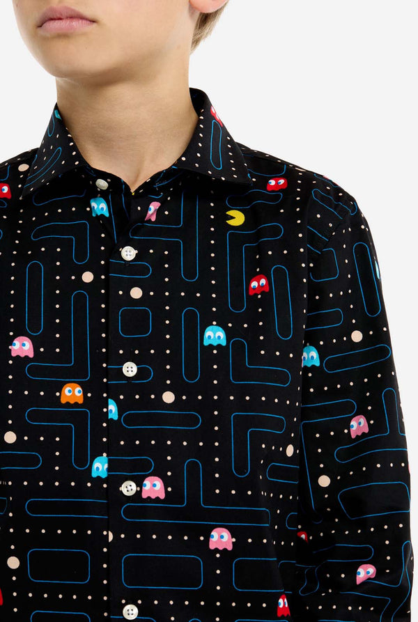 Person wearing a black shirt with colorful Pac-Man game pattern