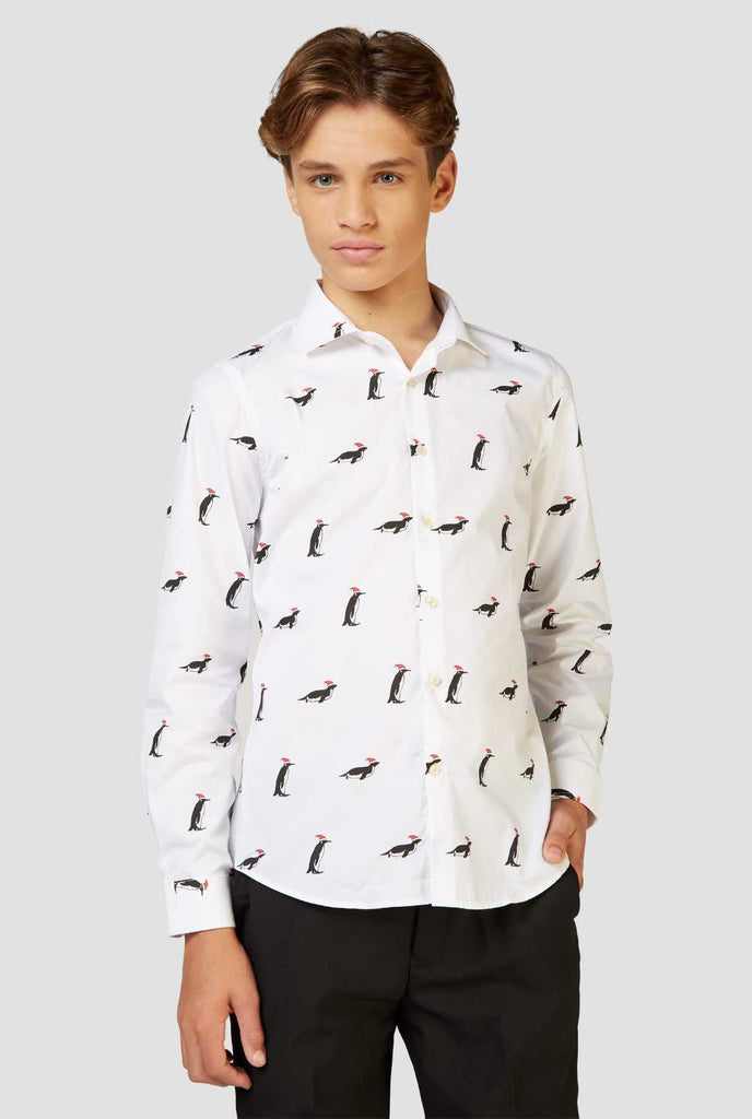 White Christmas dress shirt with Christmas penguins worn by a teen boy zoomed in