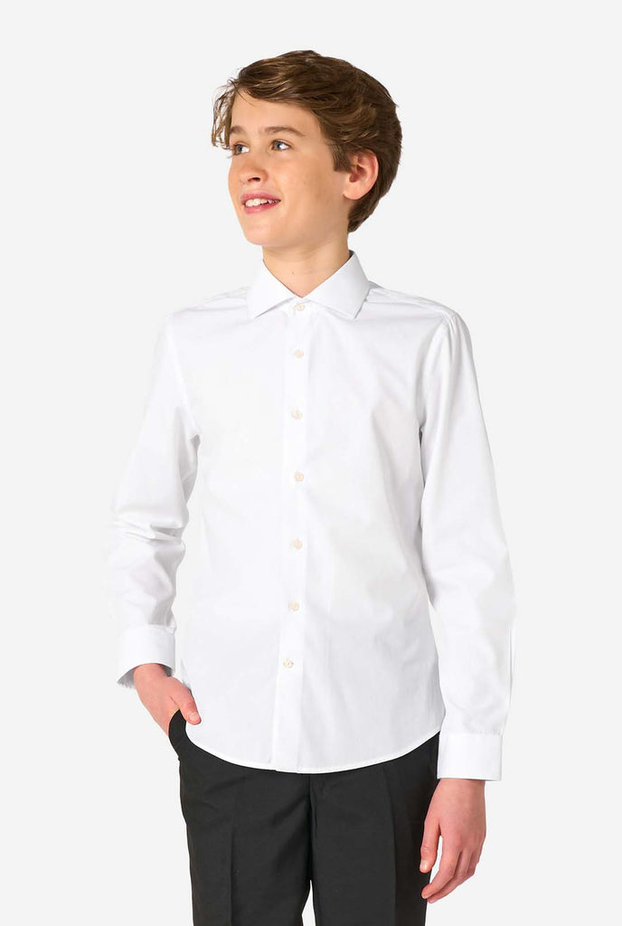 Image of long sleeve white shirt for boys worn by teen with hand in pocket. Also wearing black pants.