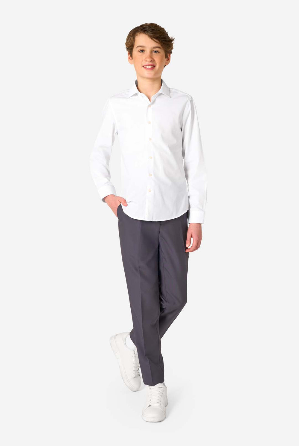 Image of long sleeve white shirt for boys worn by teen with hand in pocket. Also wearing black pants.