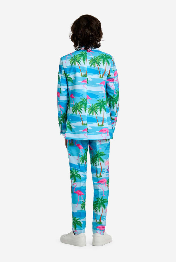Person wearing a tropical-themed outfit with palm trees and flamingos on a white background