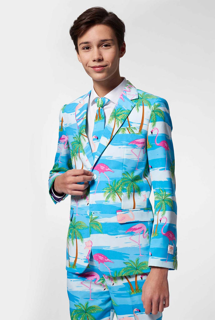 Teen wearing light blue suit with flamingo palm tree print