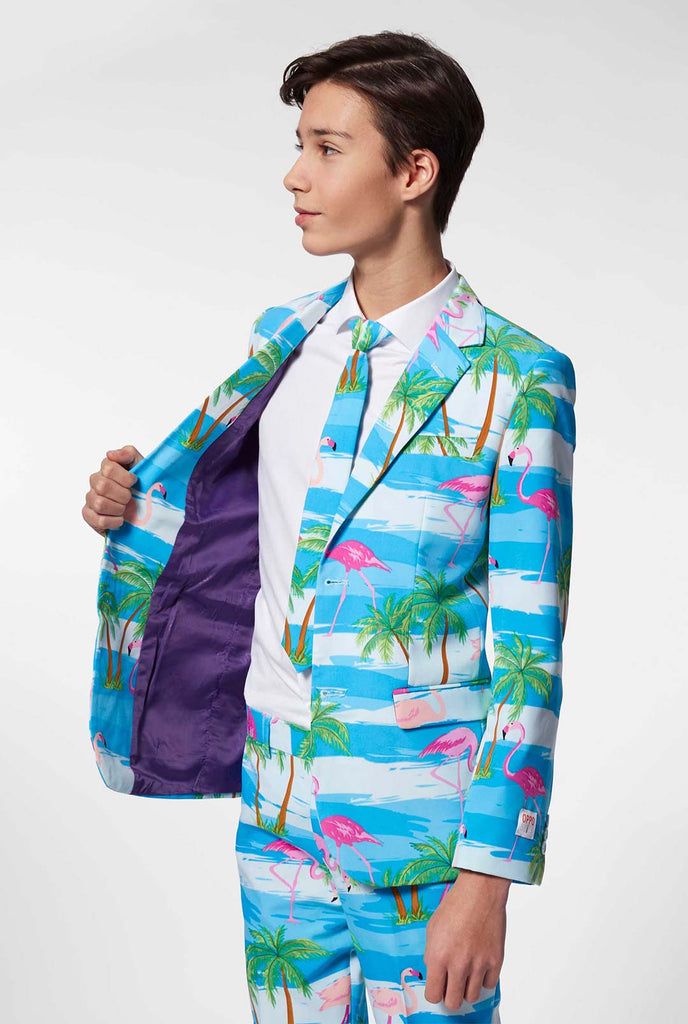 Teen wearing light blue suit with flamingo palm tree print