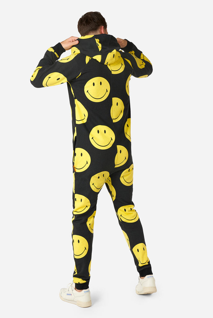 Man wearing black onesie with yellow smiley print