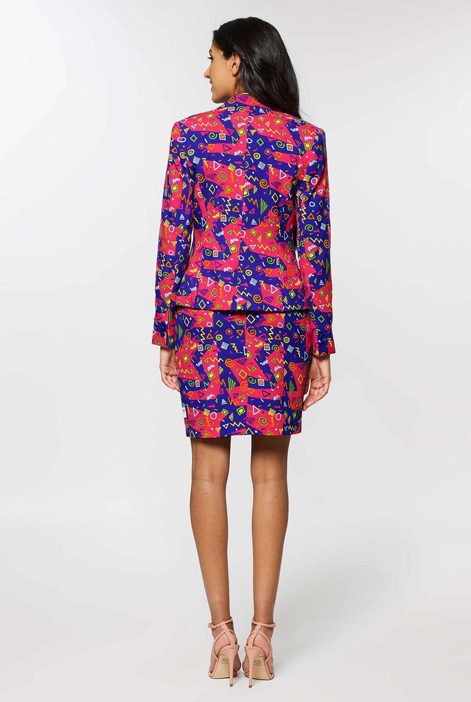 Woman wearing pink and purple suit with retro print