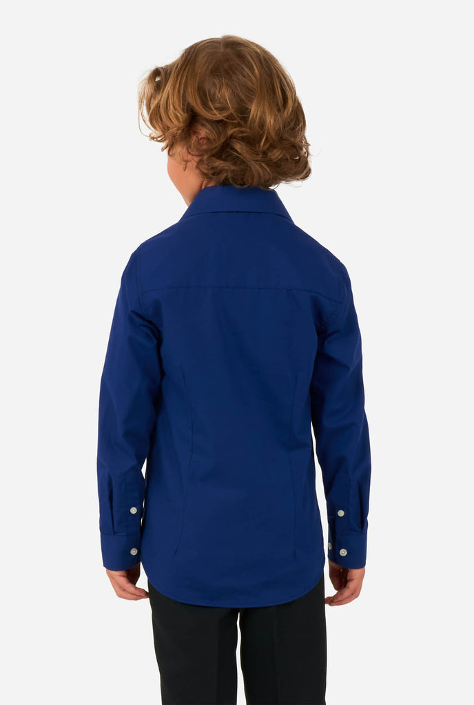 Boy wearing blue dress shirt and black pants, view from the back