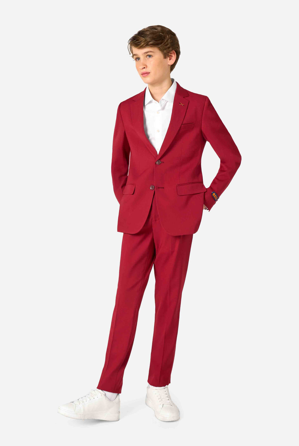 Teen boy wearing a stylish burgundy red suit with a white dress shirt, looking confidently. Perfect formal outfit for boys' special occasions, weddings, and parties.