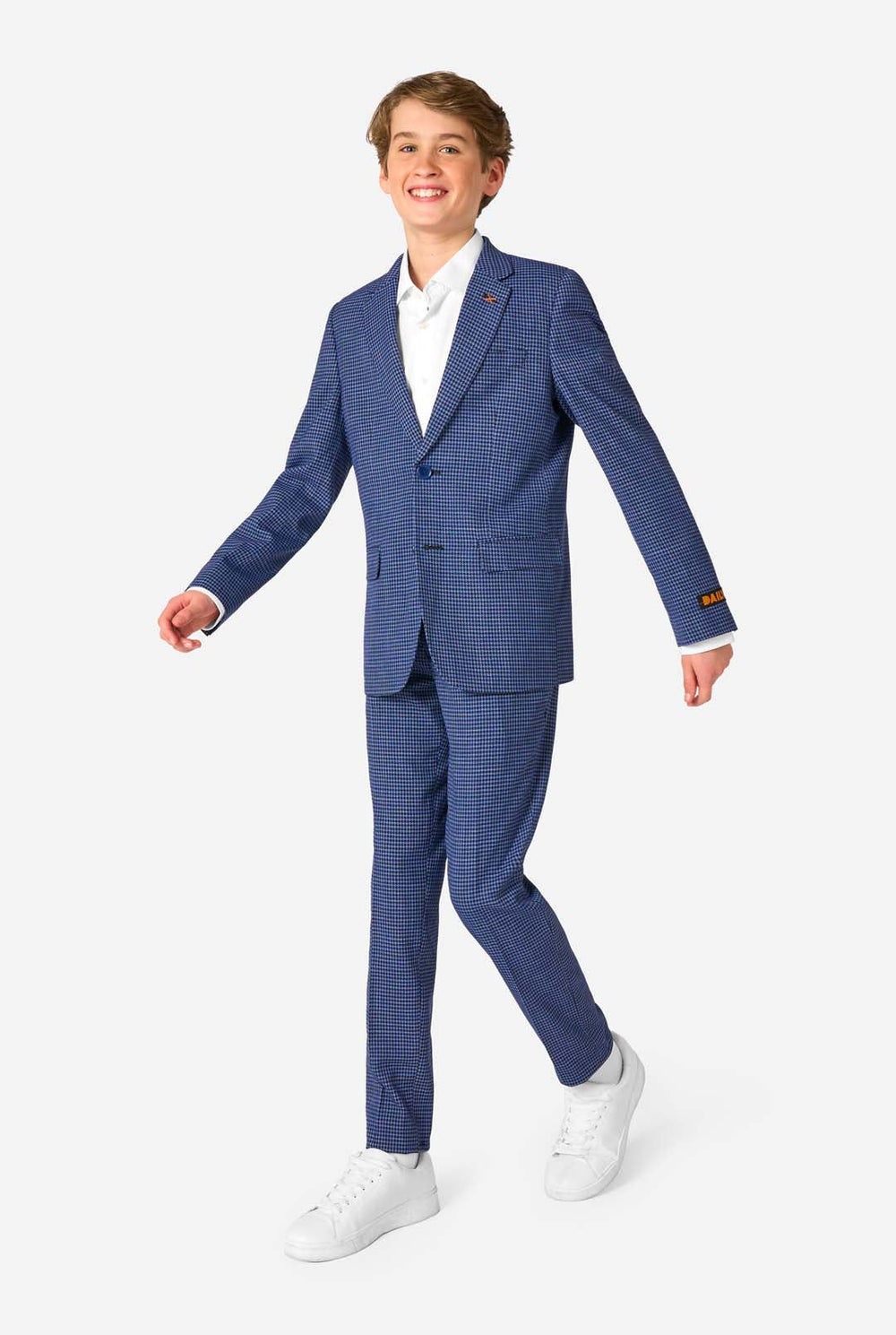 A teen boy wearing a navy and blue checkered suit with a white dress shirt. The suit has a modern fit with two buttons and flap pockets. He stands against a plain white background.