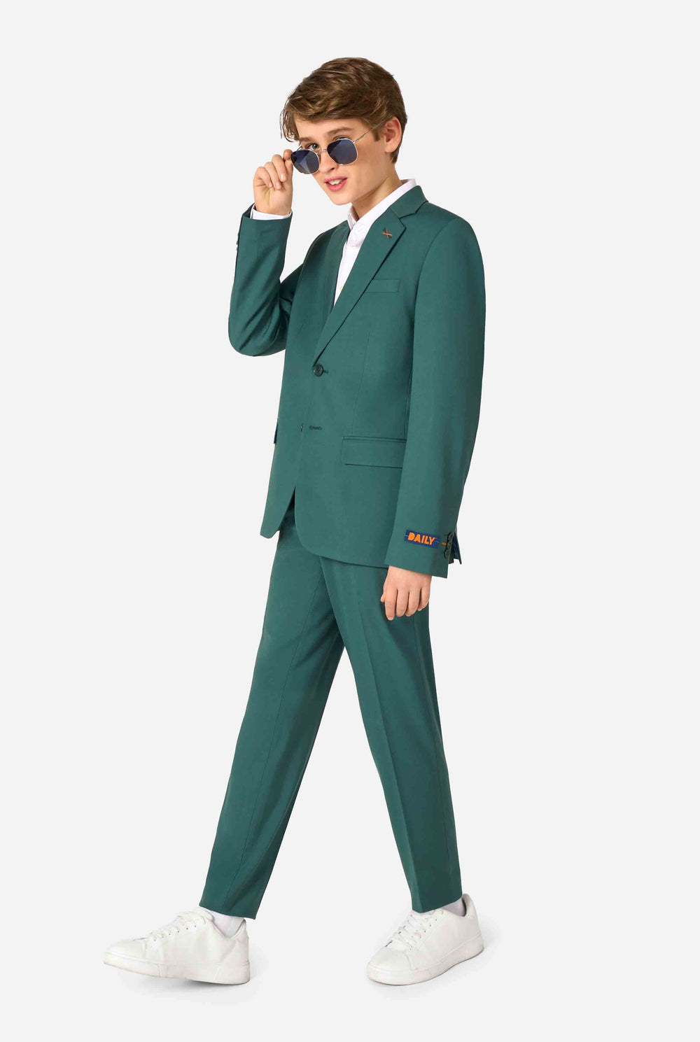 Teen boy wearing a stylish dark green suit with a white dress shirt, smiling confidently. Perfect formal outfit for boys' special occasions, weddings, and parties.