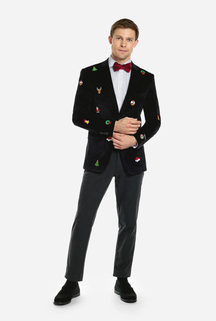 Man wearing burgundy red velvet Christmas blazer with Christmas icons