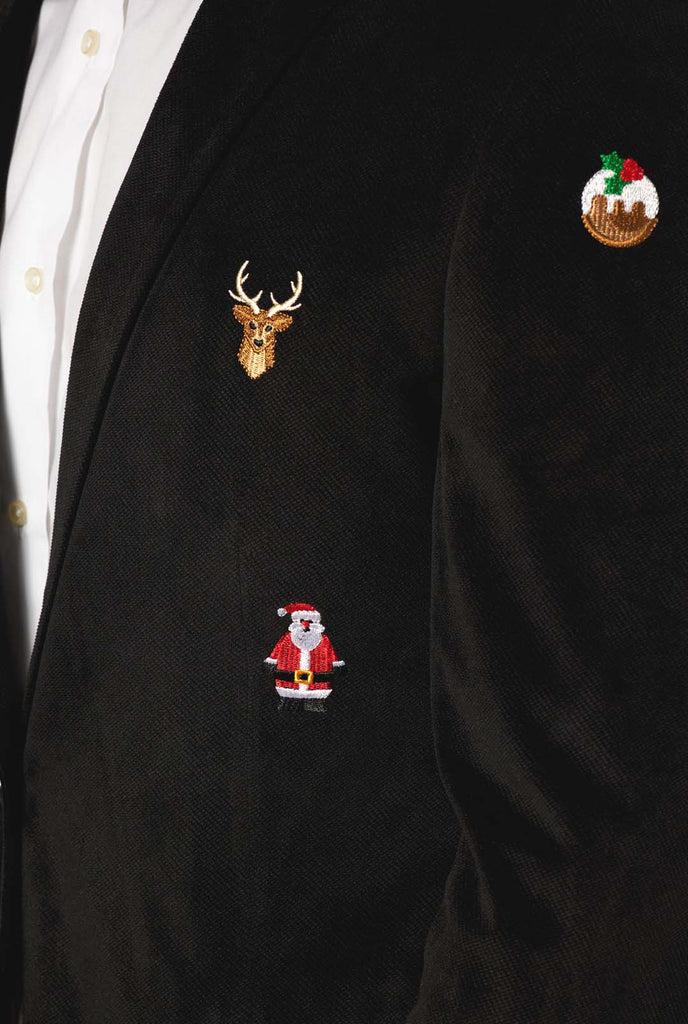 Man wearing burgundy red velvet Christmas blazer with Christmas icons, close up