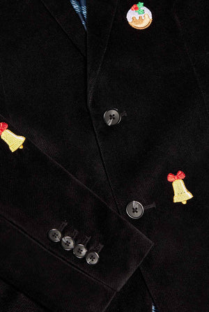 Man wearing burgundy red velvet Christmas blazer with Christmas icons, close up