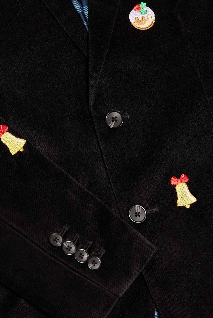 Man wearing burgundy red velvet Christmas blazer with Christmas icons, close up